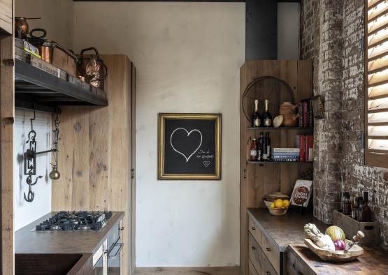 a kitchen with a brick wall and a framed picture