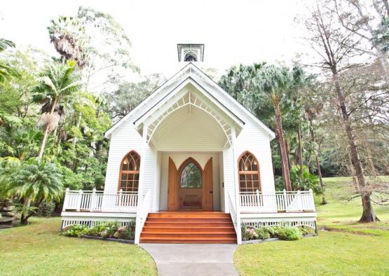 a white church with a porch and stairs