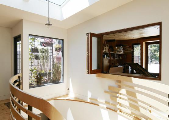 a room with a skylight and a wooden railing