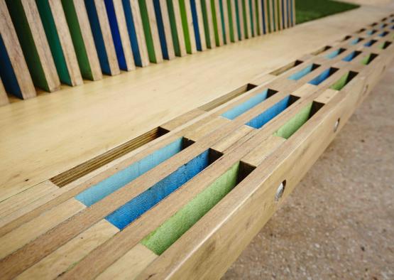 a wooden bench with colorful strips