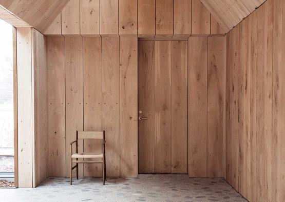 a wooden room with a chair and a pencil