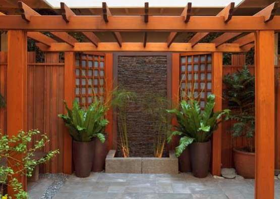 a wooden pergola with plants in pots