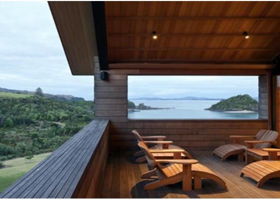 a deck with chairs and a view of the ocean