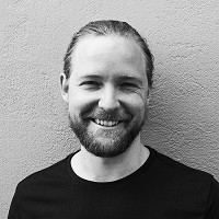 a man smiling at the camera