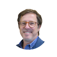 a man wearing glasses and smiling