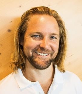 a man with long hair and beard smiling