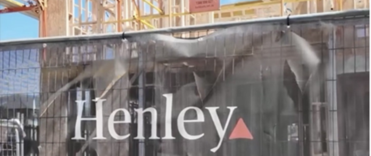 Henley sign in front of timber framed home