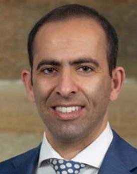 a man in a suit smiling
