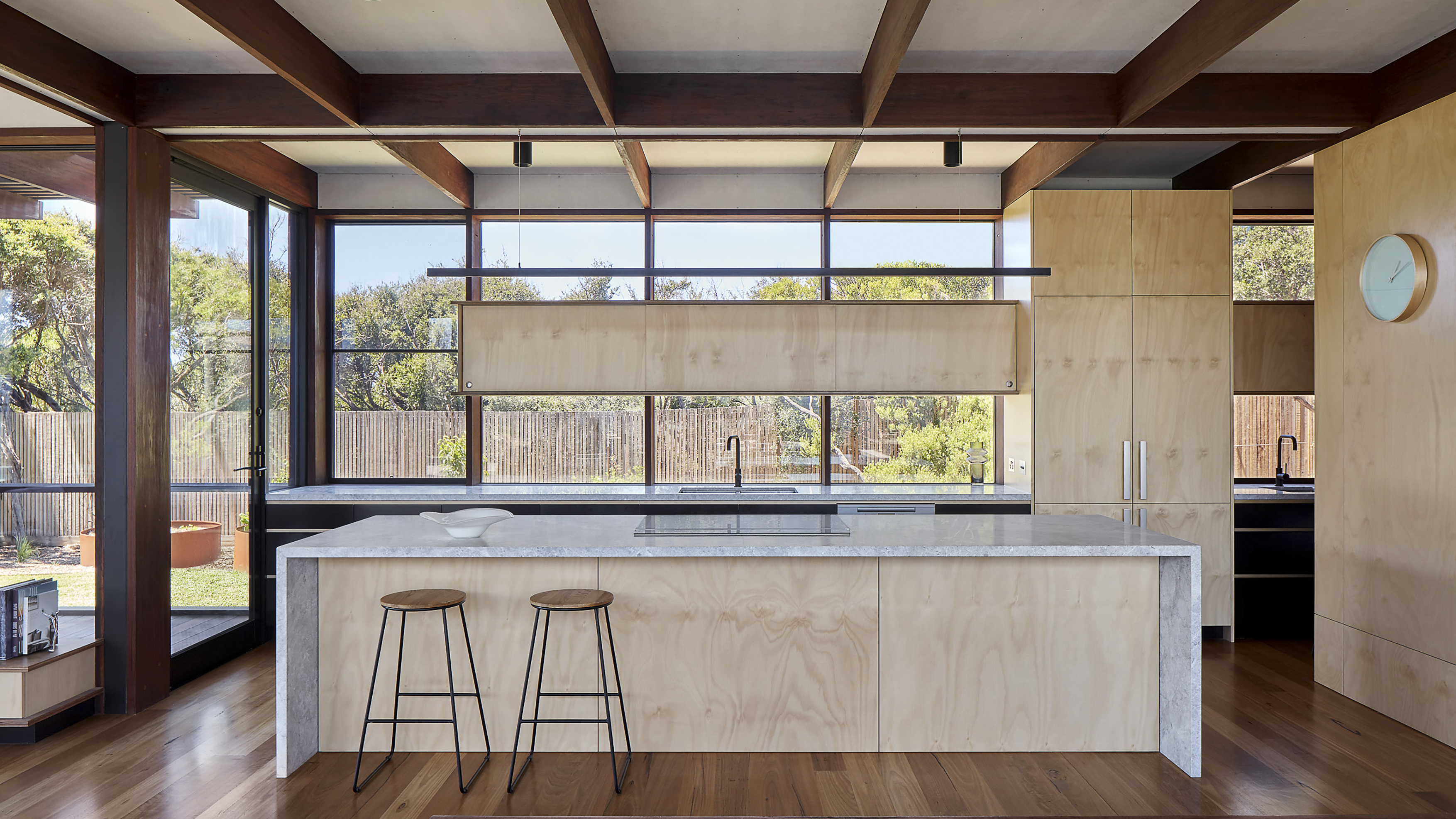 a kitchen with a bar and stools