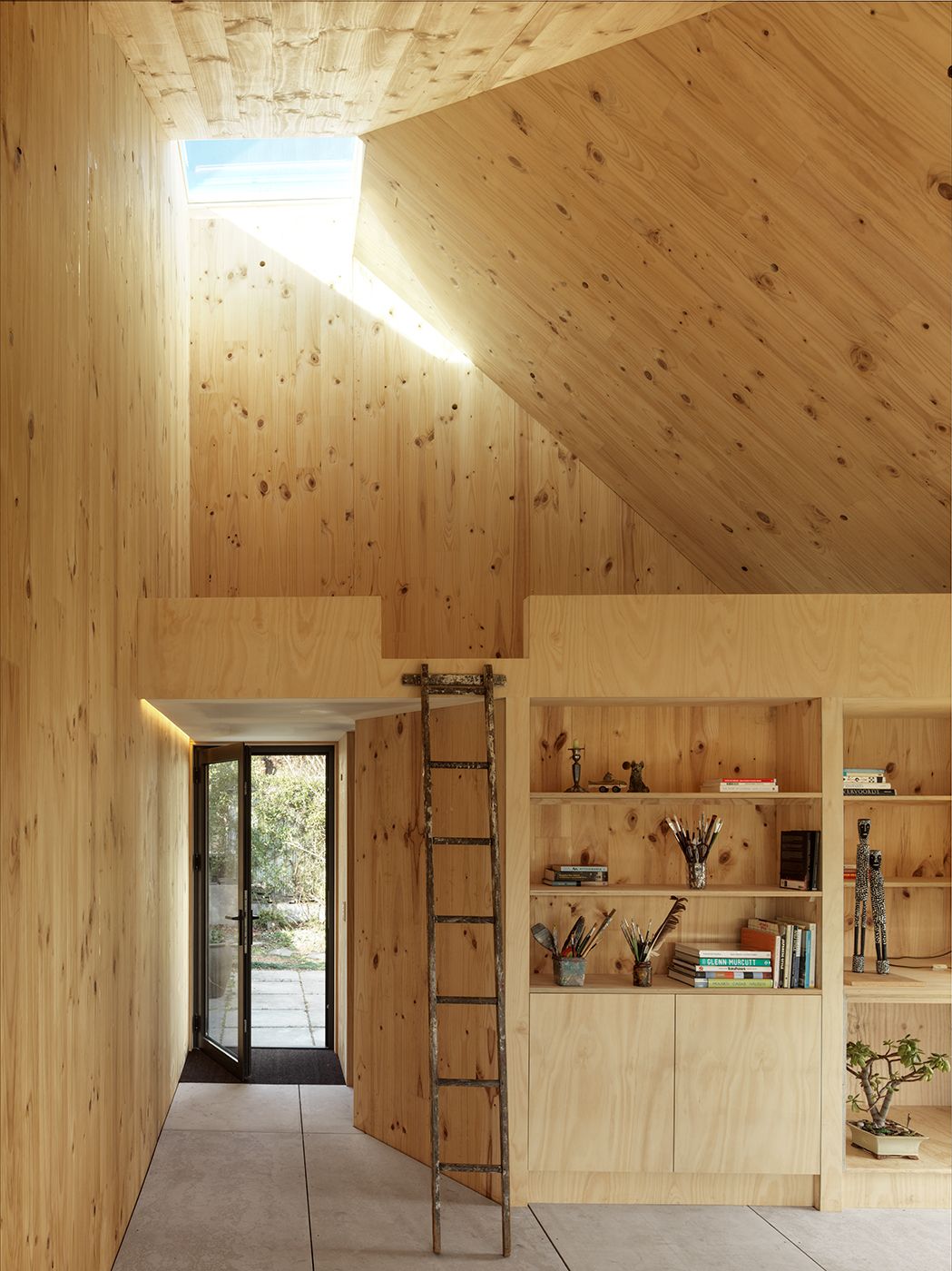 a room with a ladder and shelves