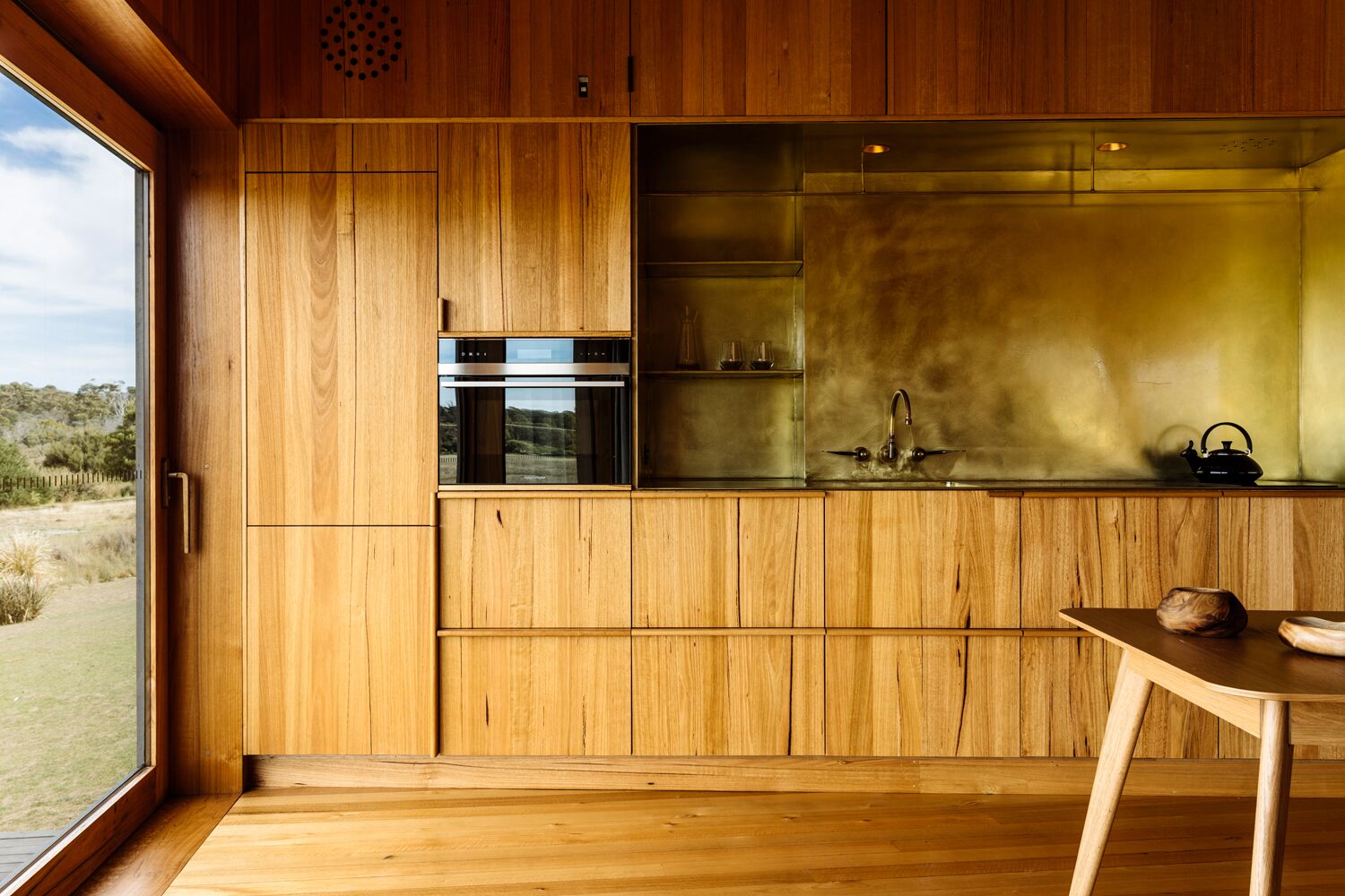 a kitchen with wood cabinets and a table