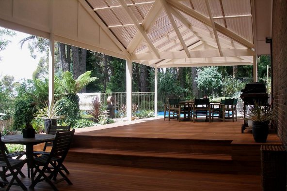 a patio with a deck and chairs