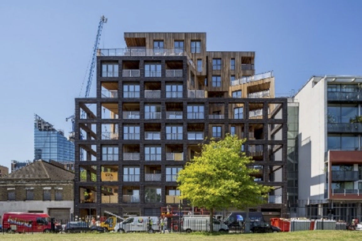 a building under construction with a tree