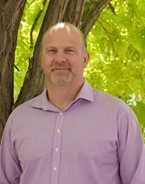 a man in a purple shirt