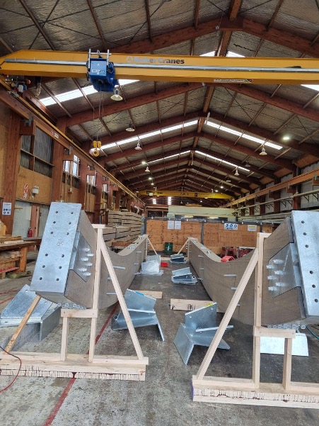 Curved timber elements prior to shipping with intermediate steel nodes fit. Source: Red Stag TimberLab.
