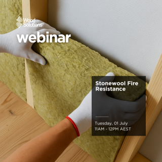 Person wearing gloves installing stonewool in a timber framed wall