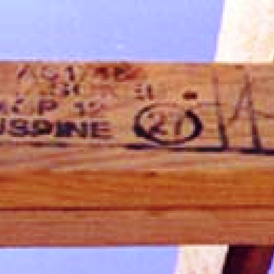 a piece of wood with writing on it