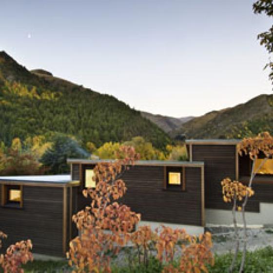 Arrowtown House – Dark horizontal cedar weatherboards with small openings to street