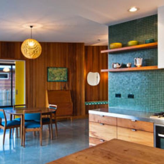 Nelson House – Cedar cladding extends inside giving the house a 70s feel. The kitchen is macrocarpa