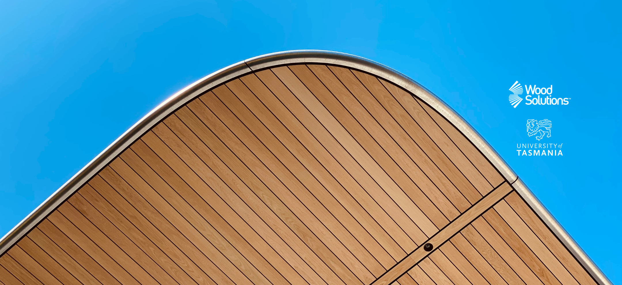 Wood lined roof against a blue sky. Logos: WoodSolutions and the University of Tasmania