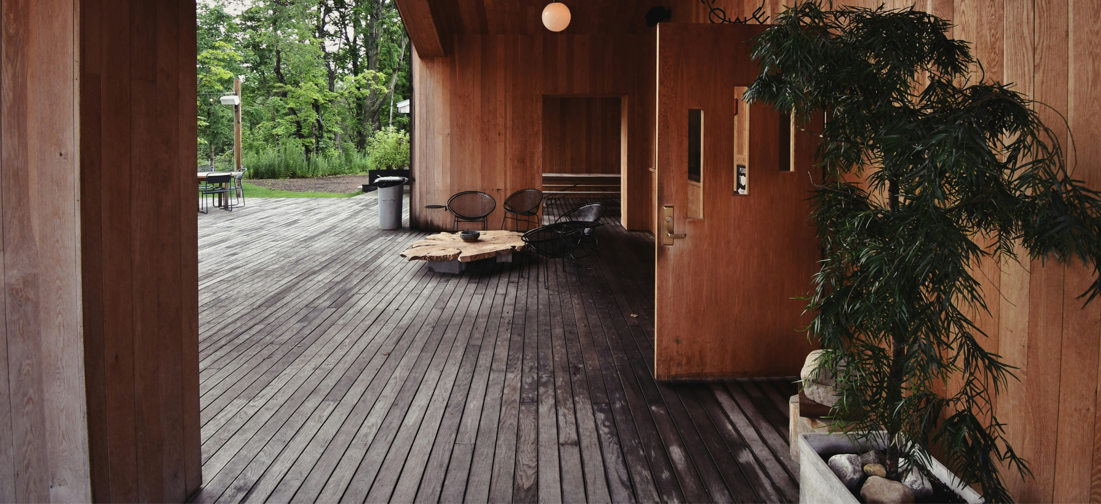 Looking through building with timber deck, walls, and door