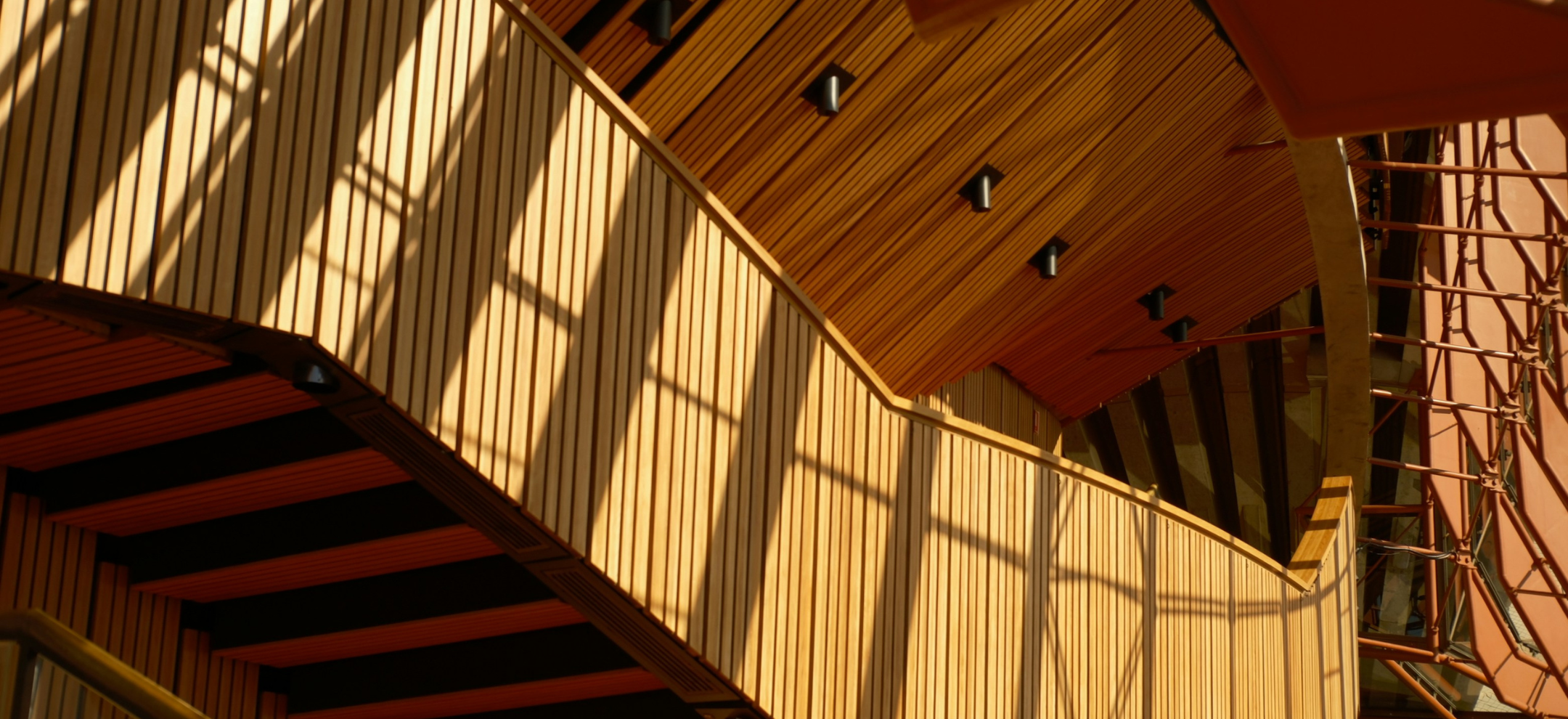 Shadowed view of timber balconies inside Sydney Opera House Theatre