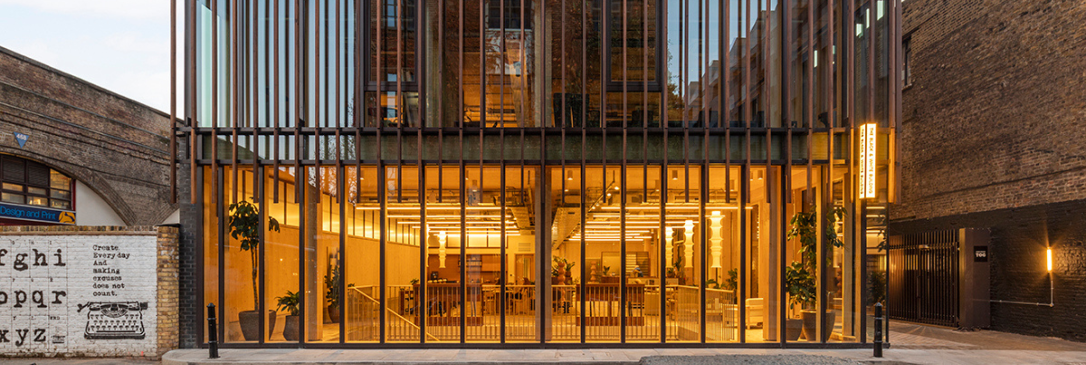 Image of building front illuminated at sunset