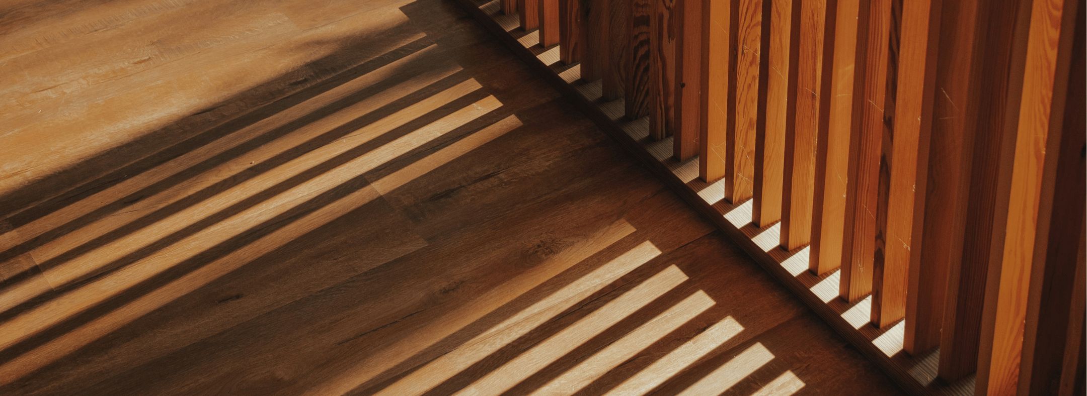 Hardwood timber wall casting shadows on hardwood timber floor