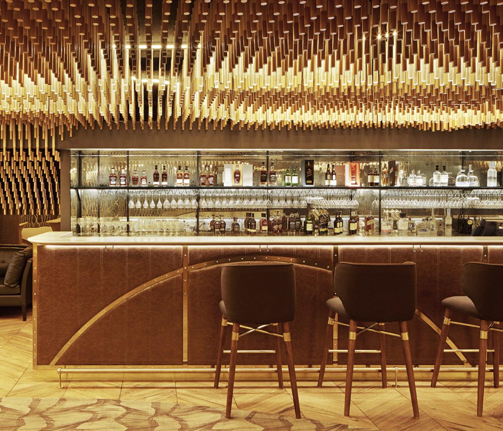 a bar with chairs and bottles