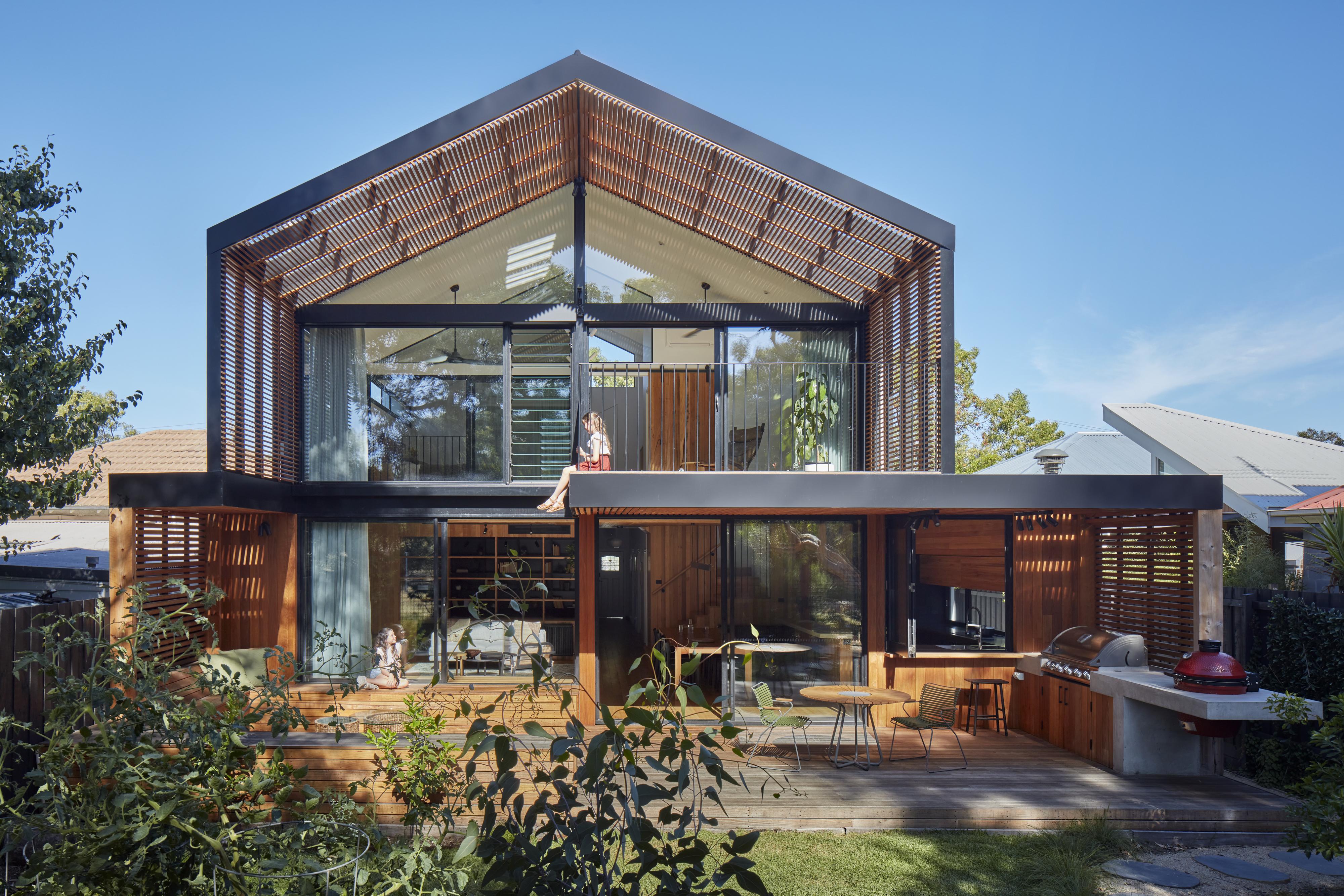 a house with a patio and a couple of people sitting on the porch