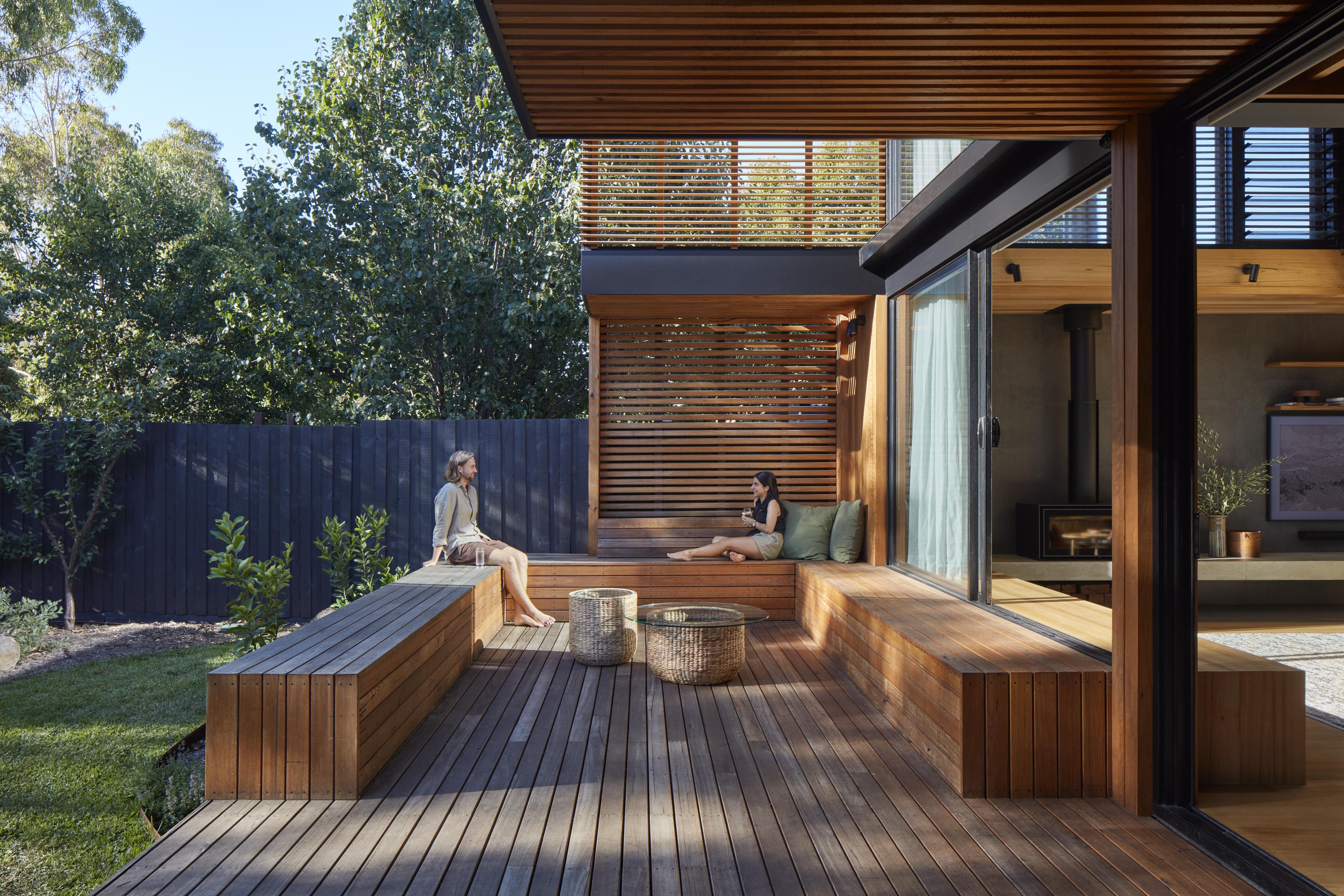 a couple of women sitting on a deck