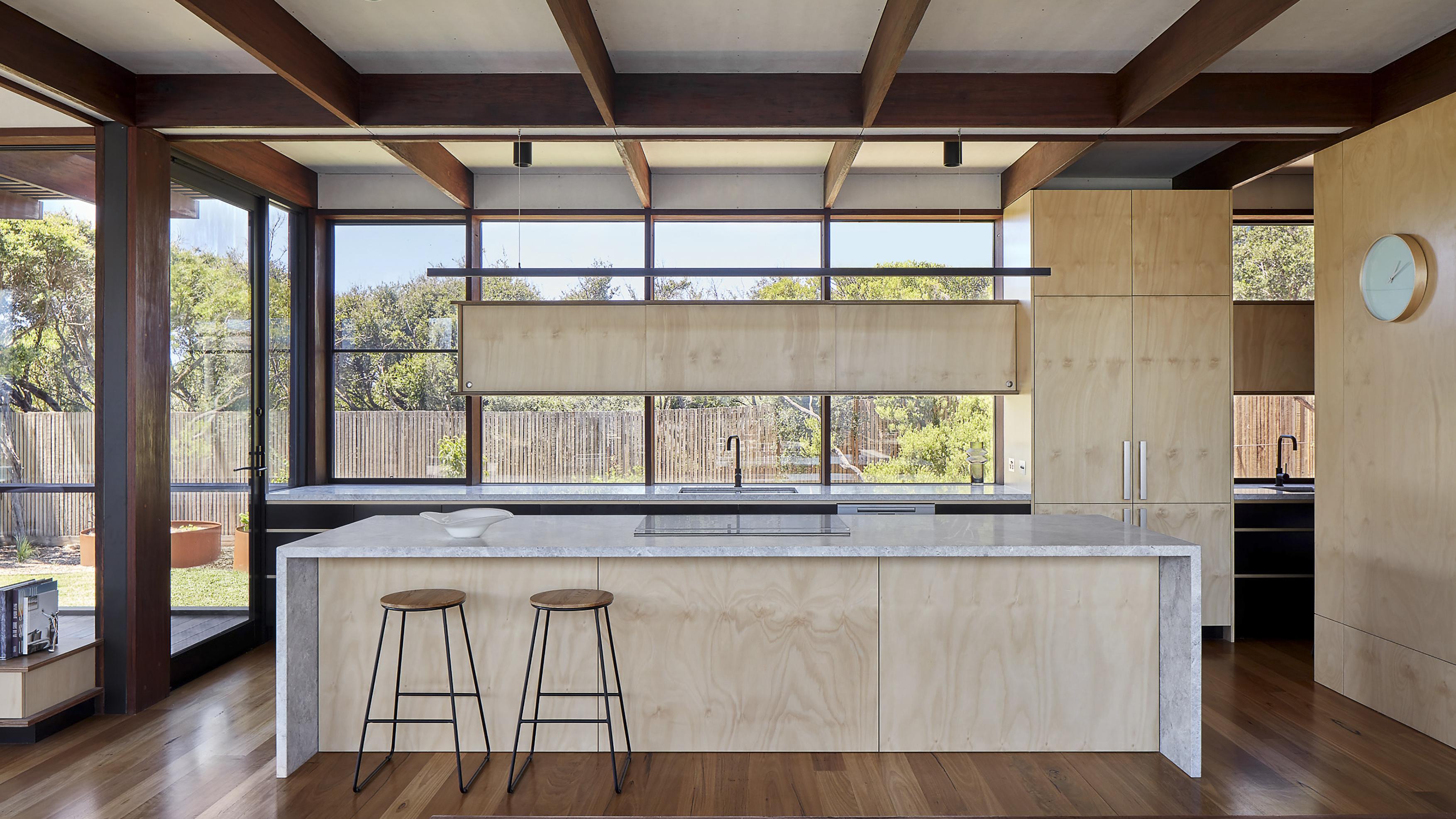a kitchen with a bar and stools