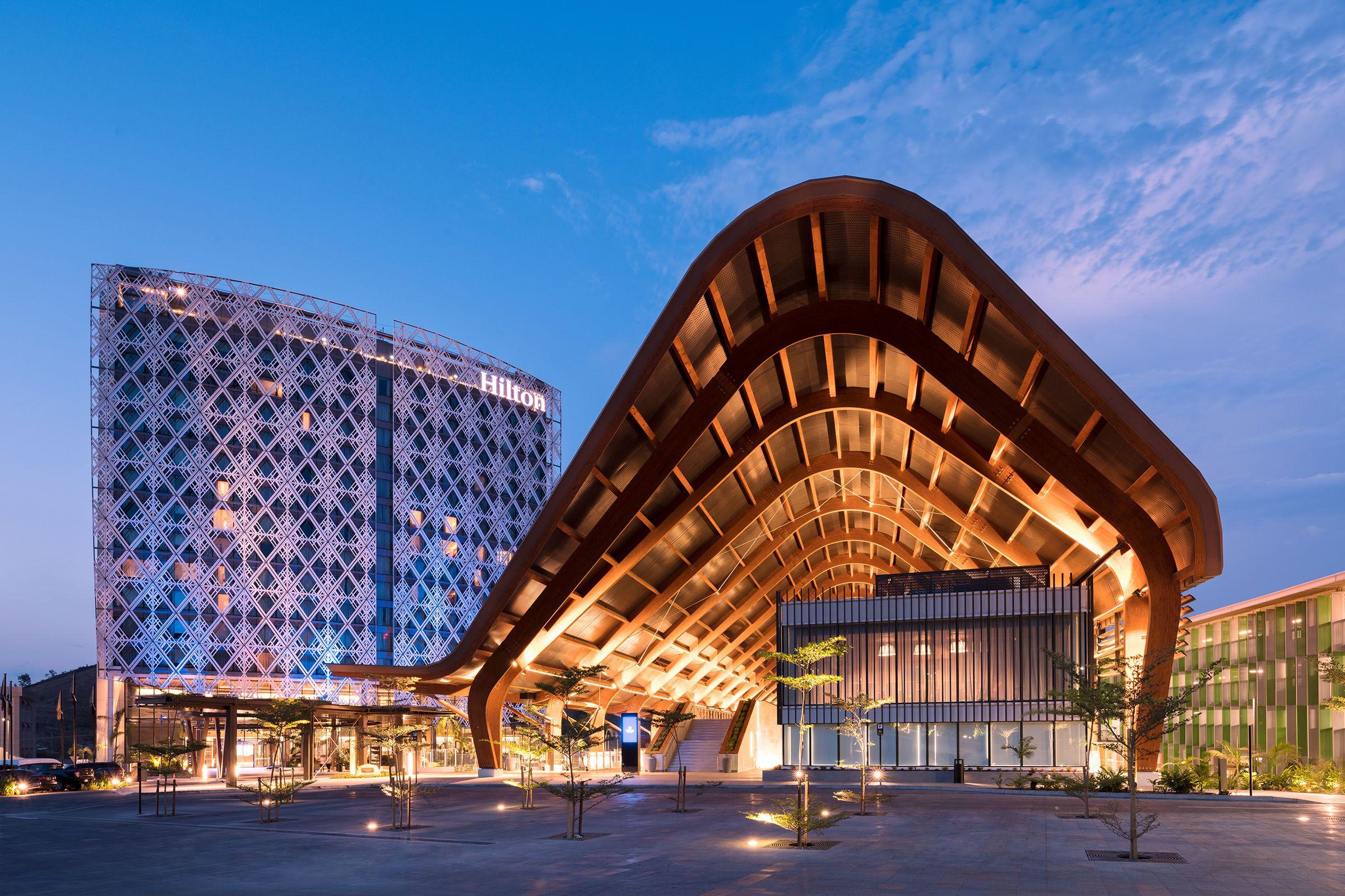 a building with a curved roof and a building with a blue sky