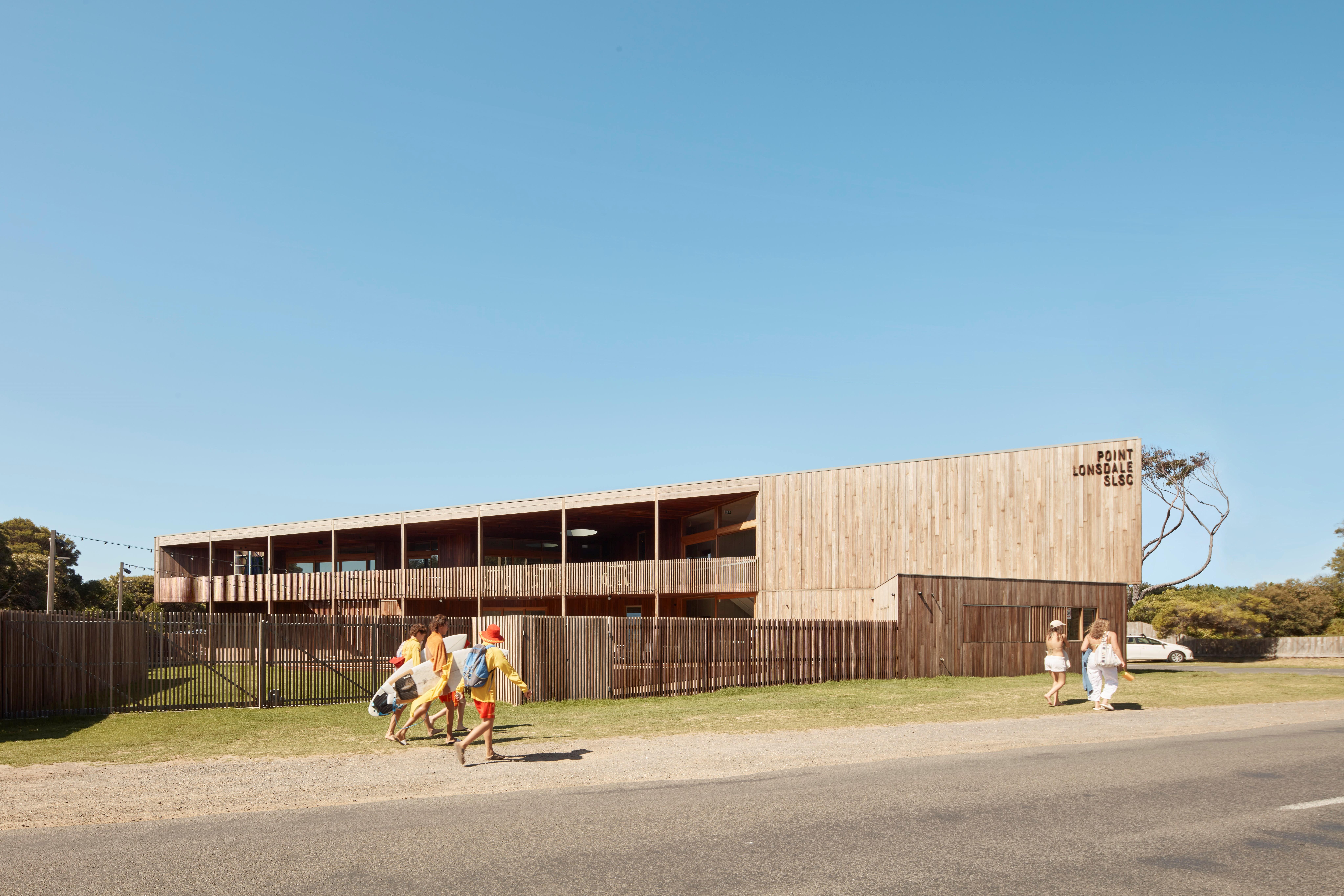 a group of people walking by a building