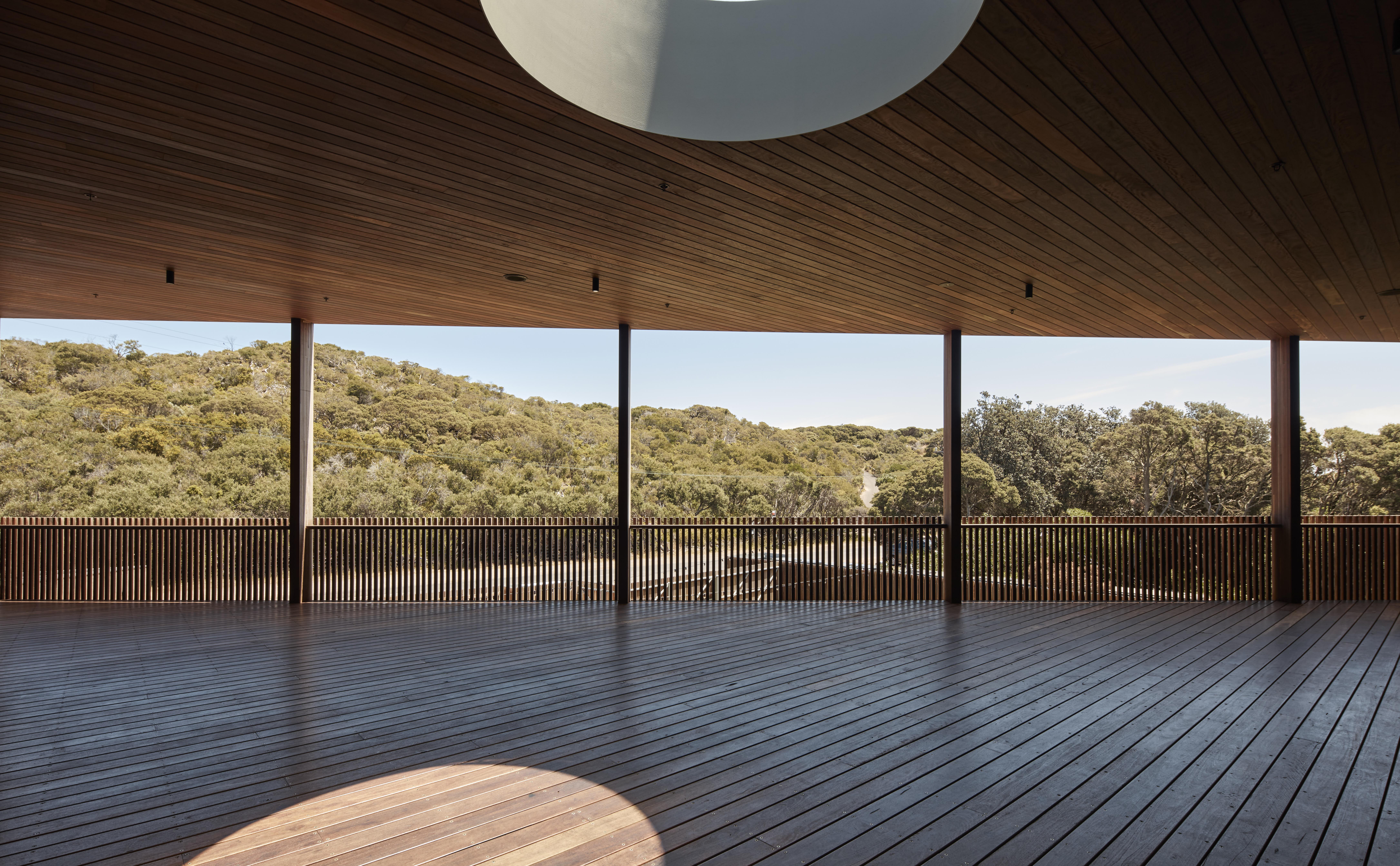 a large wooden room with a large white light fixture