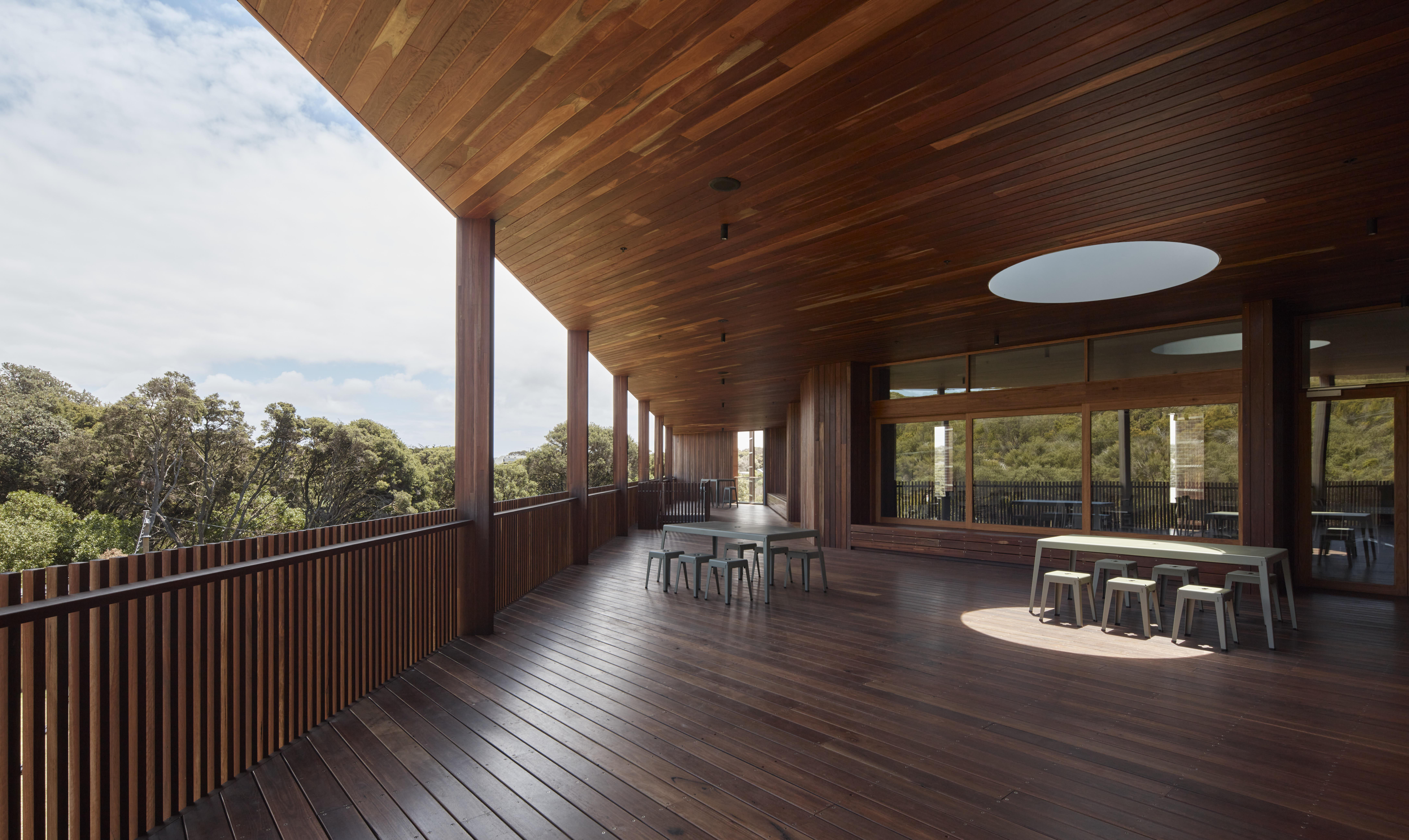 a wooden deck with tables and chairs