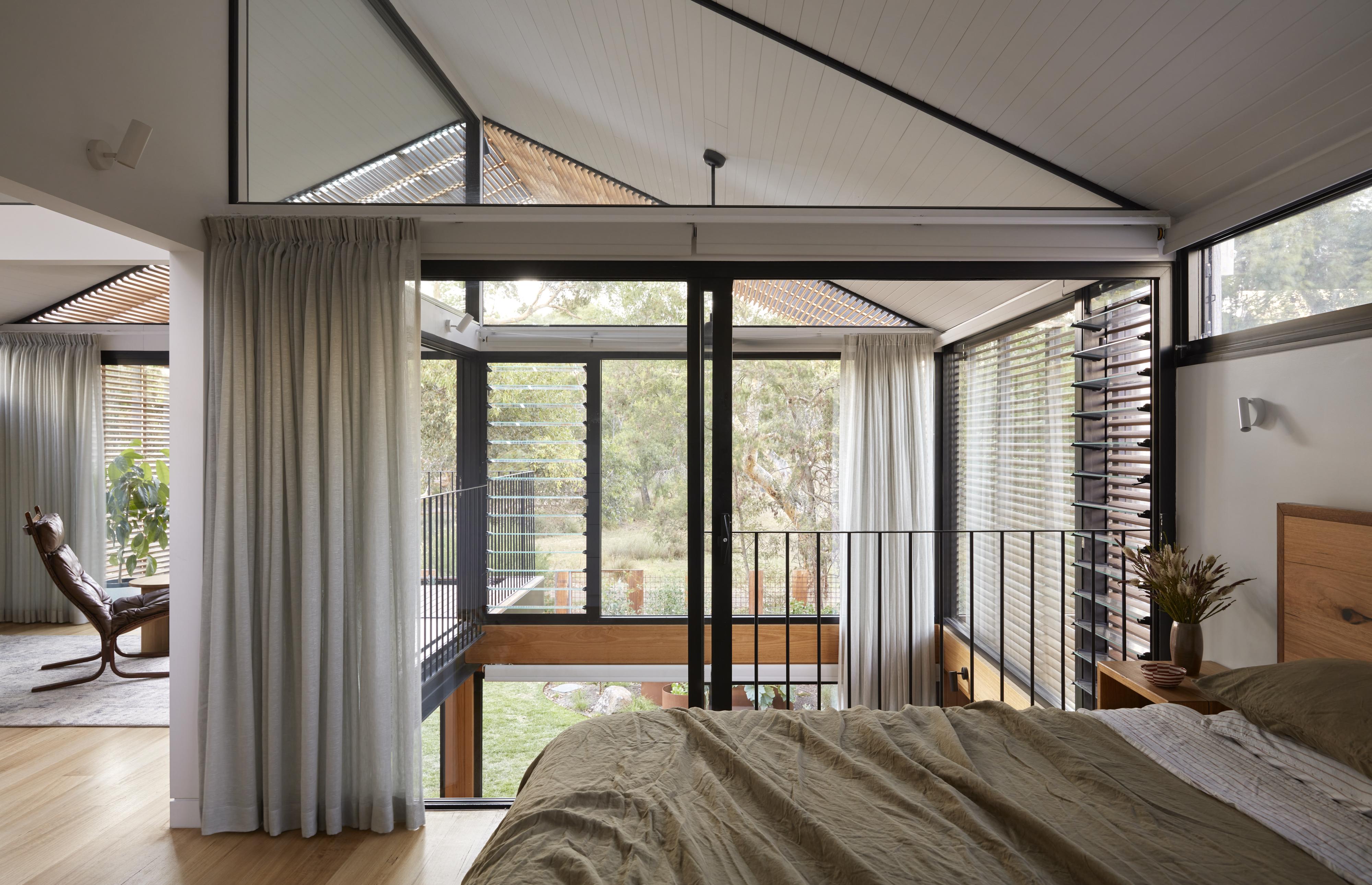 a bedroom with a balcony and a bed