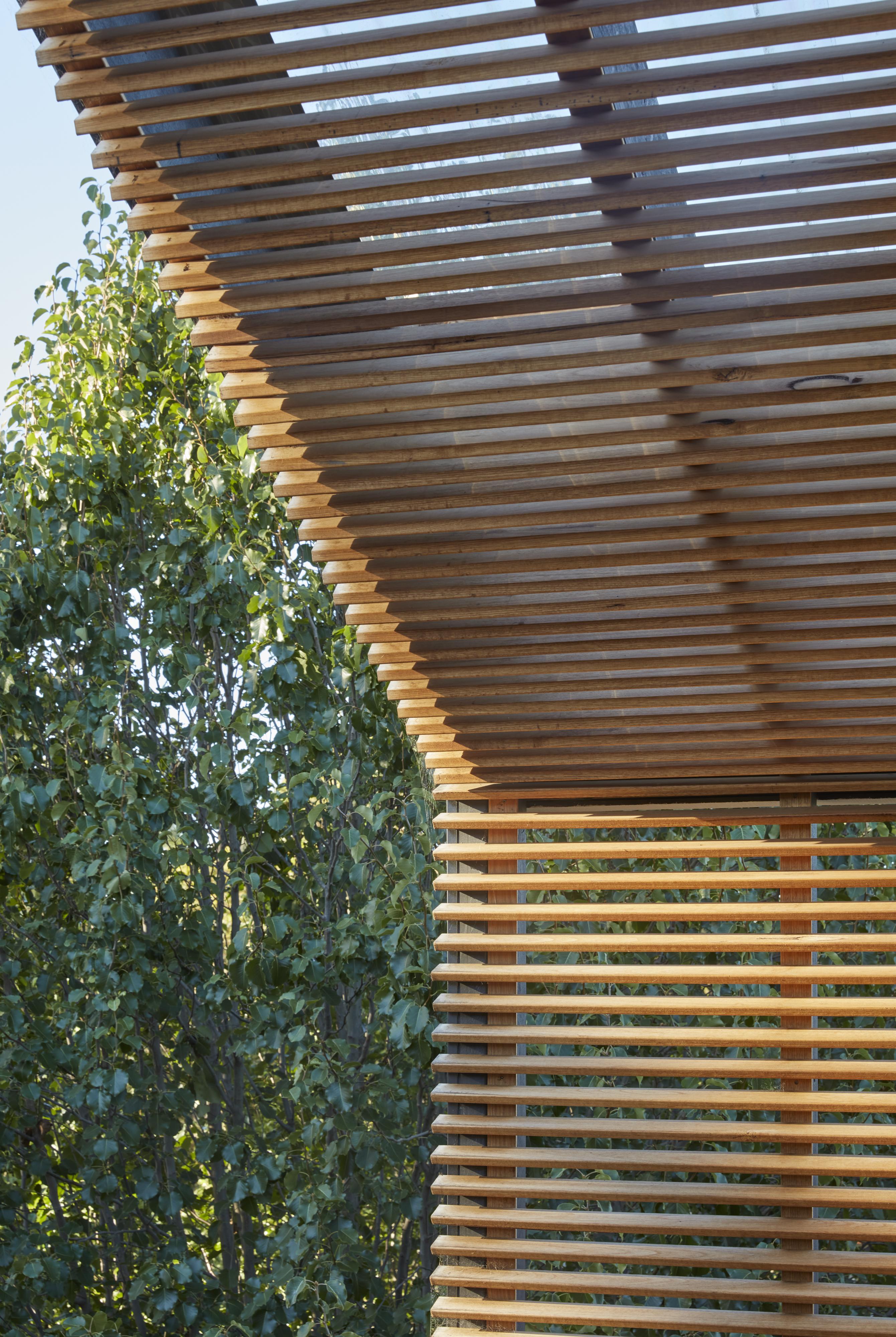 a wooden structure with trees in the background
