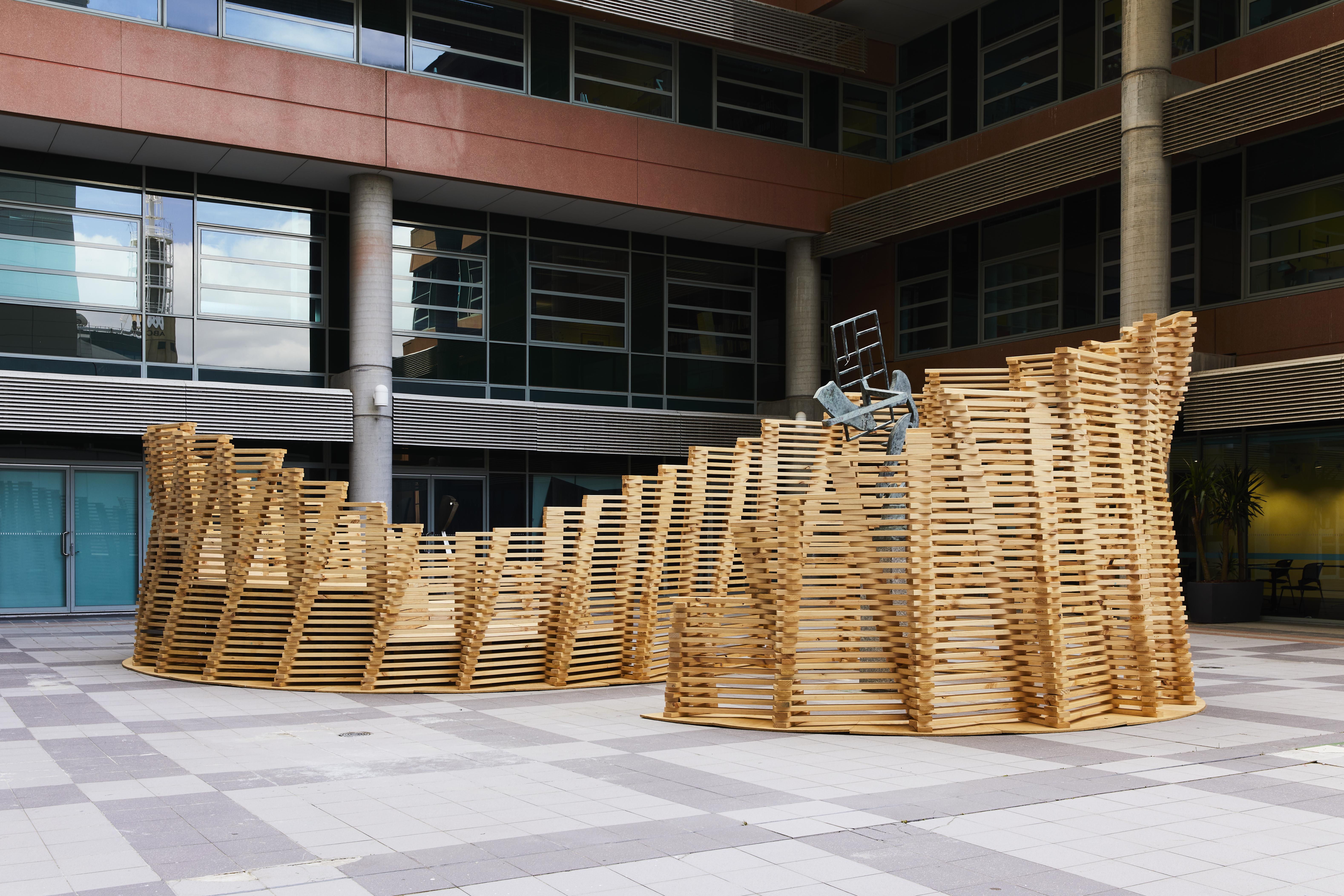 a group of wooden pieces in front of a building