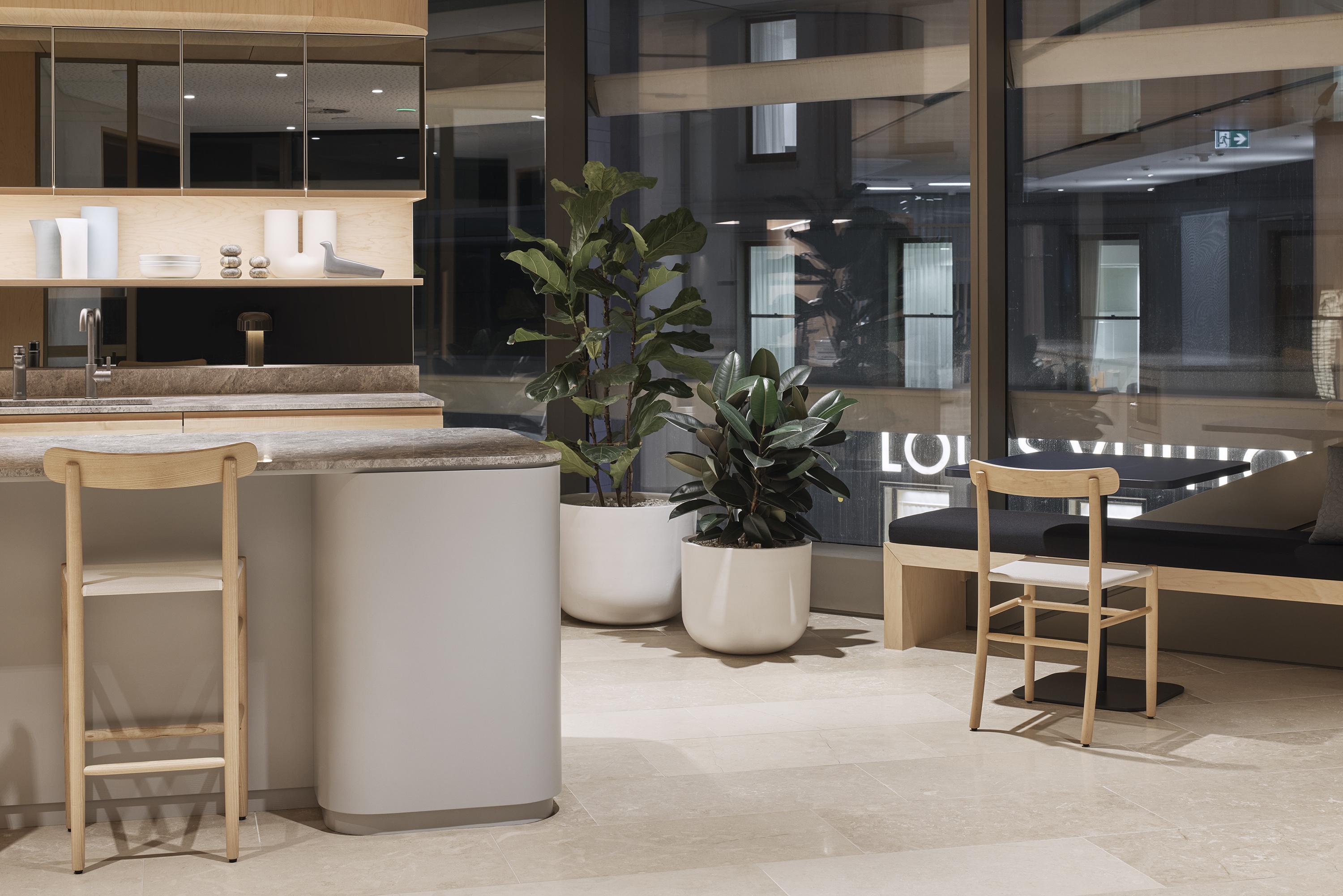 a room with a table and chairs and a plant