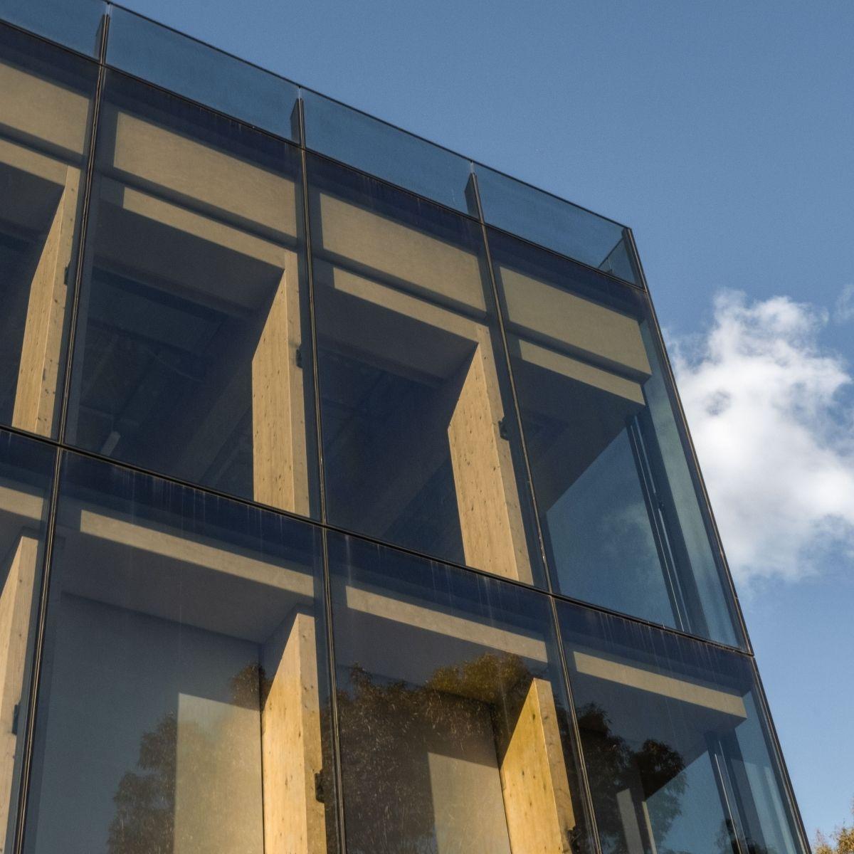 Macquarie University Ainsworth Building exterior, showing glass windows looking in on exposed structural timber