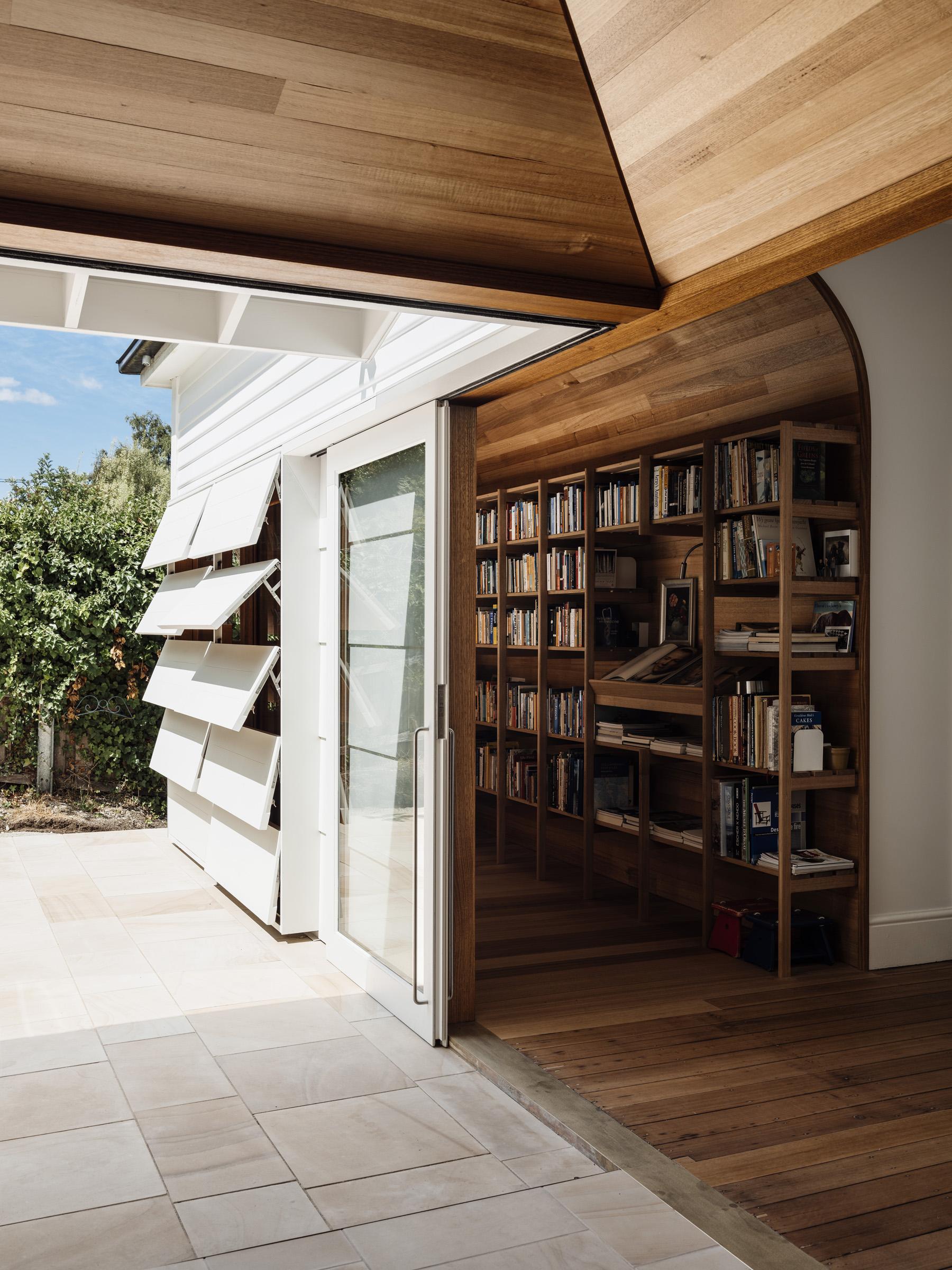 a room with a bookcase and a door open