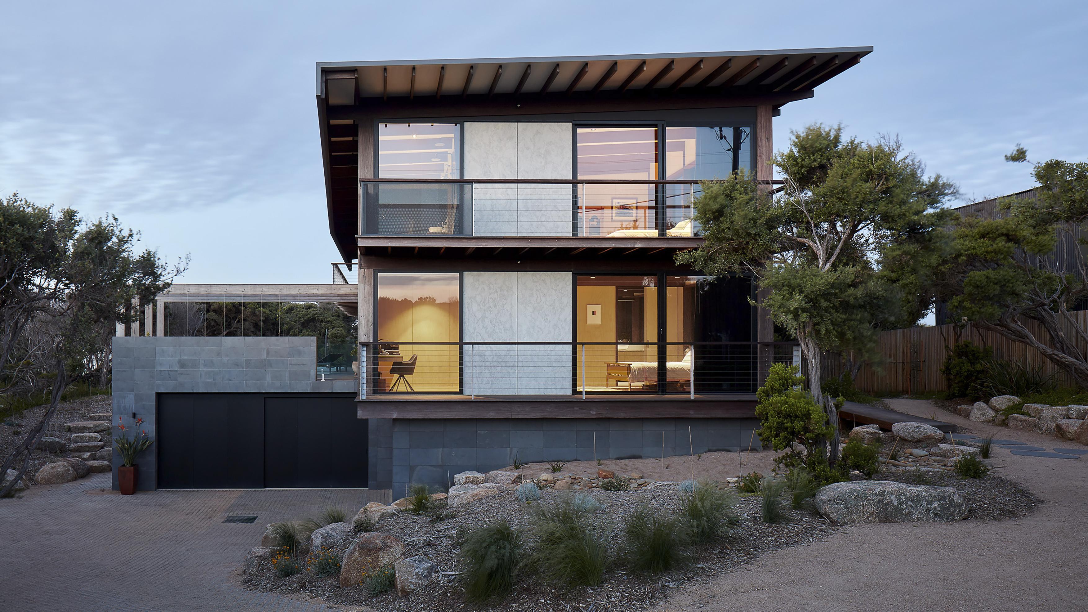 a house with a garage and a tree