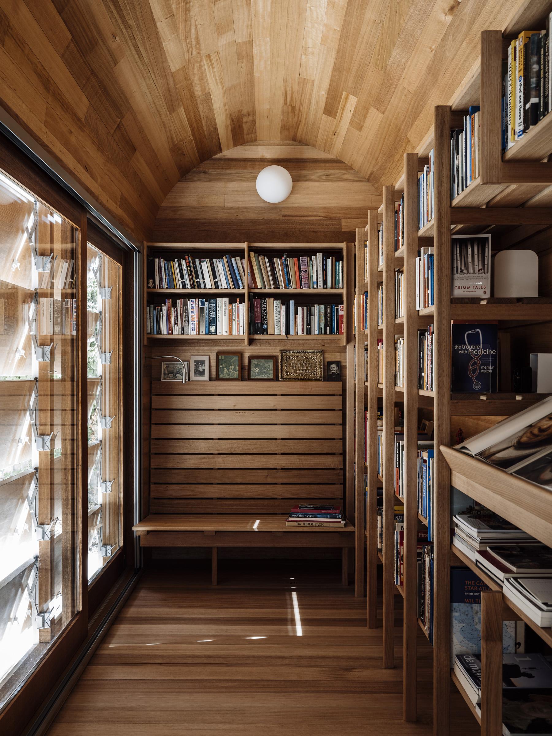 a room with a wood wall and shelves with books
