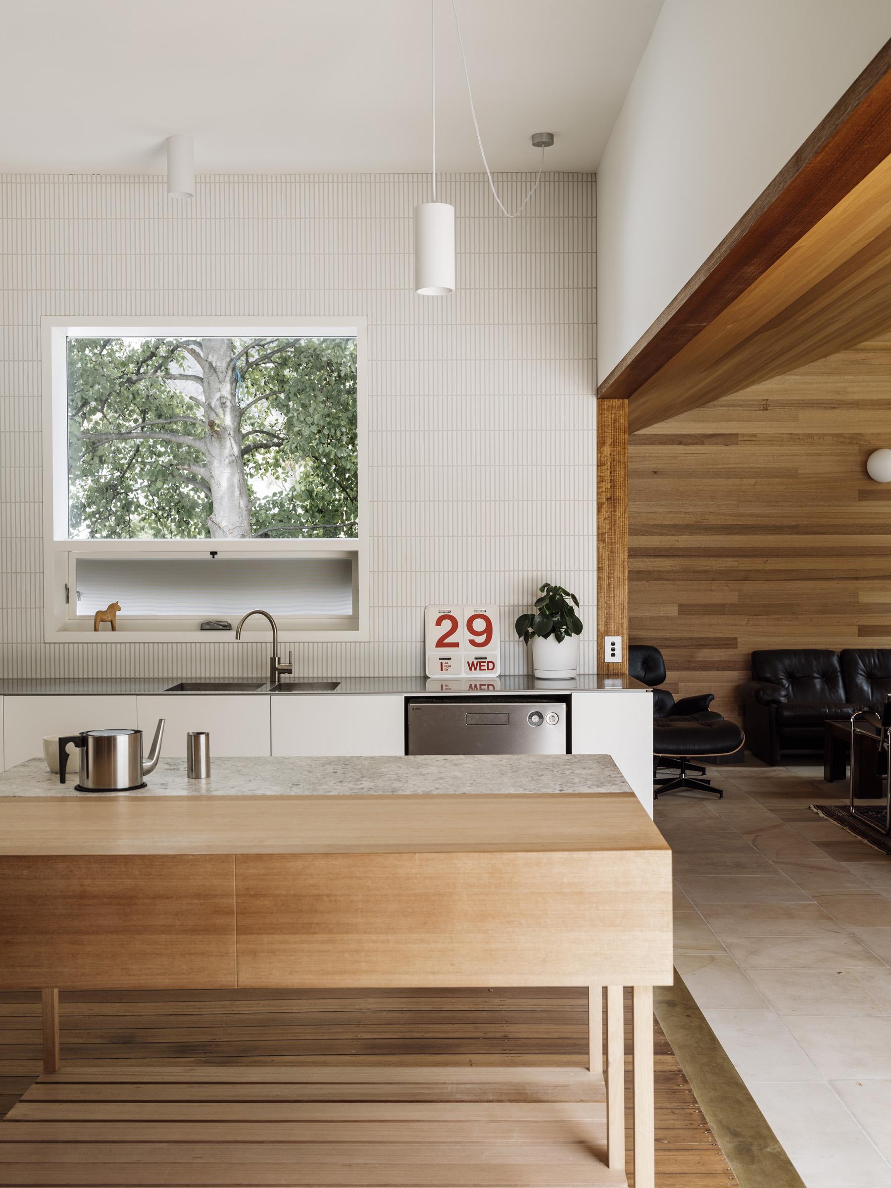 a kitchen with a wood countertop and a couch