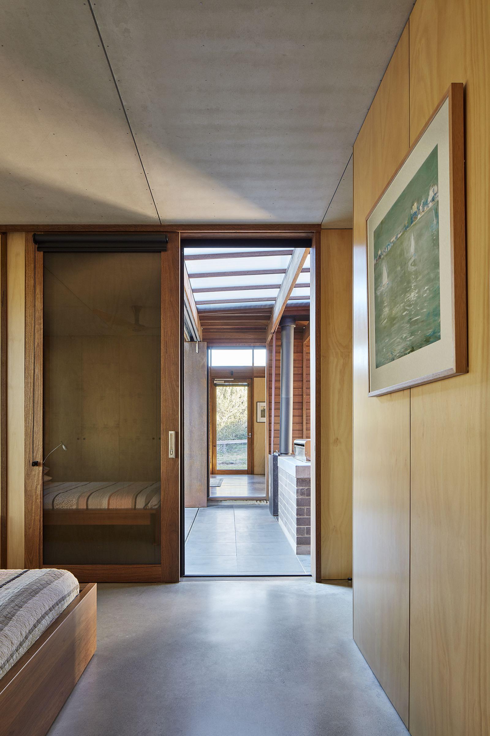 a hallway with a bed and a painting on the wall