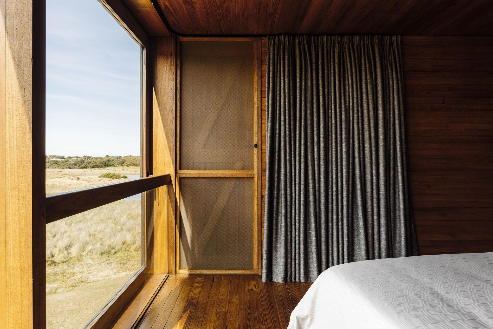 a room with a window and a bed