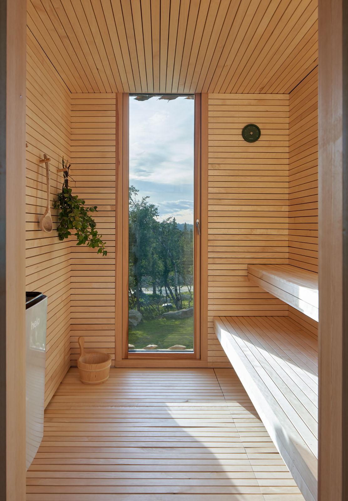 a wooden room with a window and a wood bench