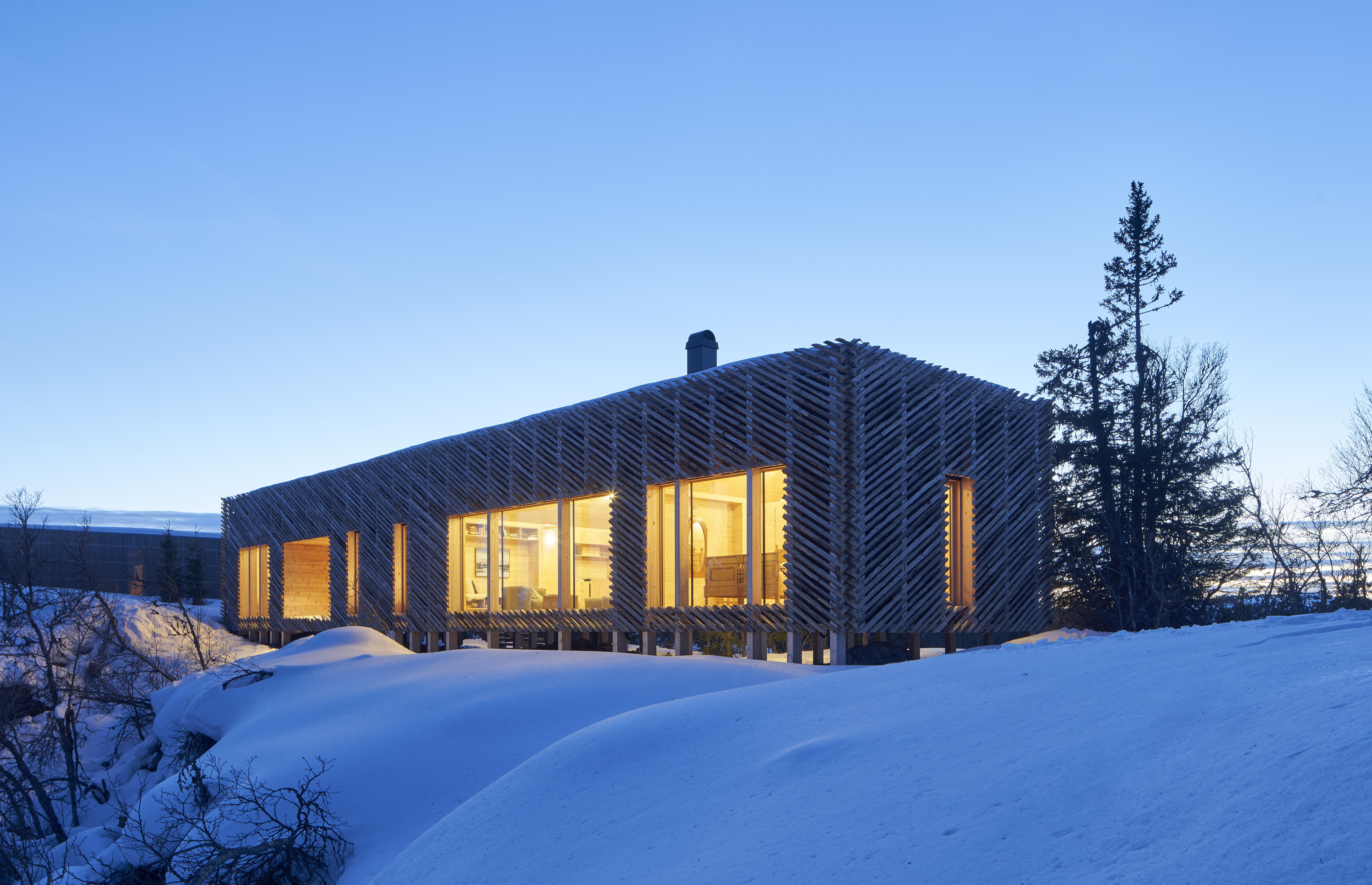 a building with a wooden structure in the snow