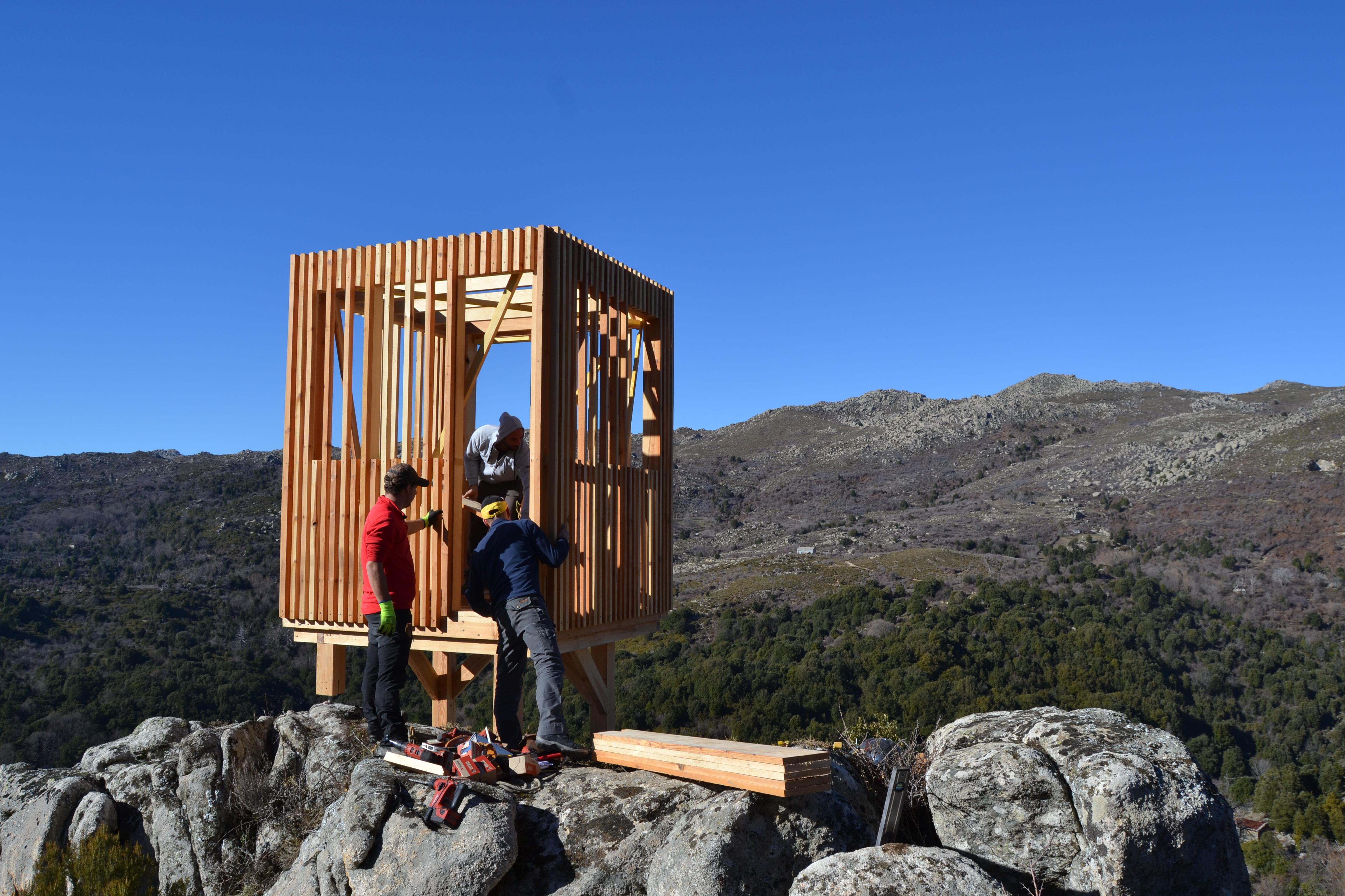 a group of people standing on a wooden structure